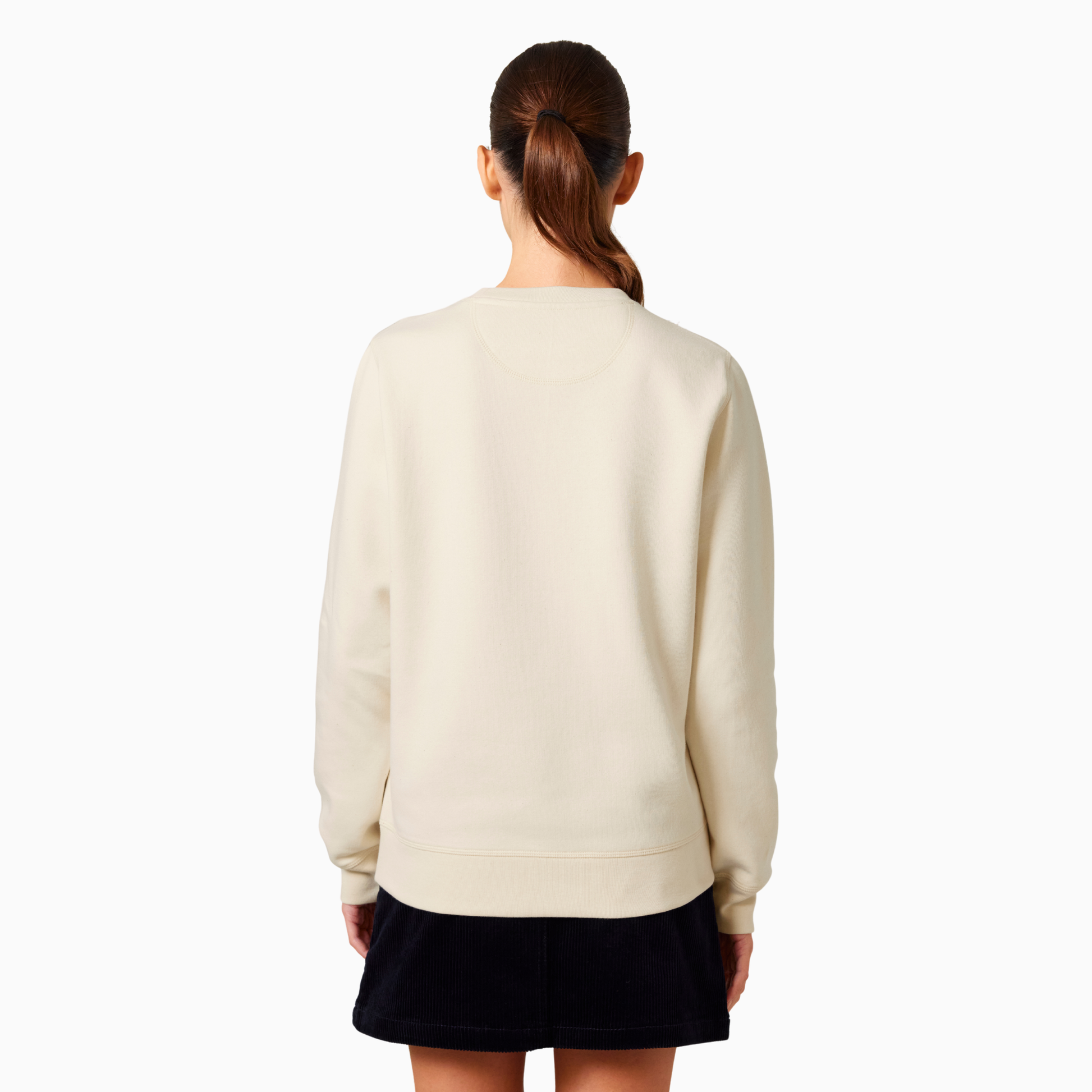 Person wearing a light cream sweater and black skirt on a white background